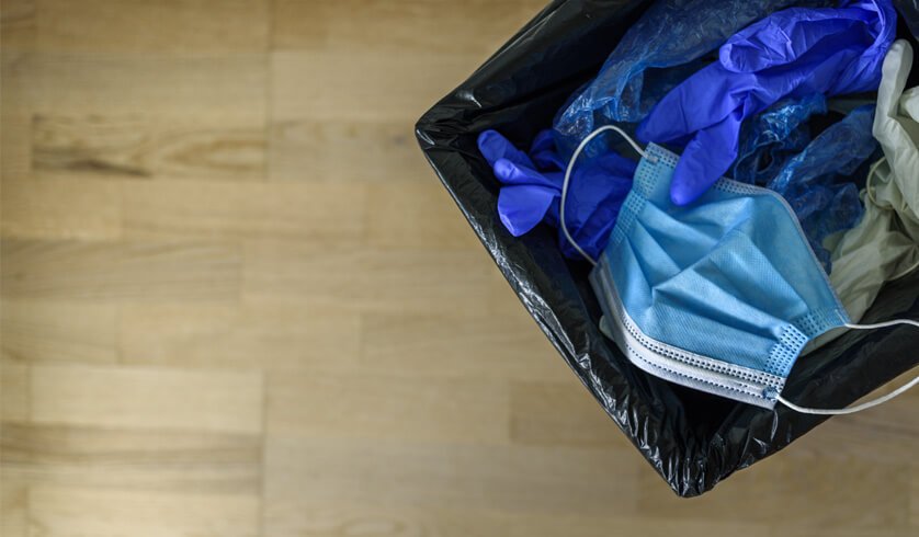 Lata de lixo com descarte de resíduos hospitalares como luva e máscara de proteção